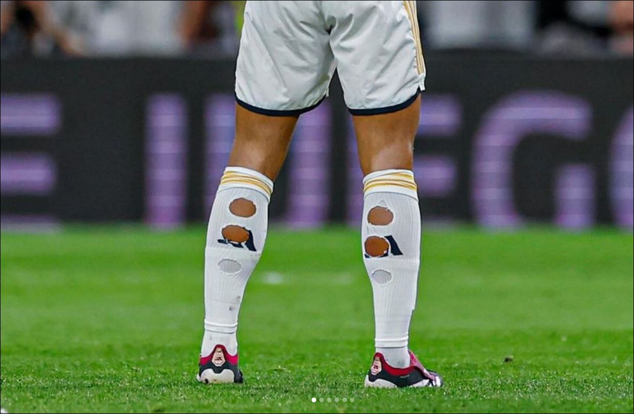 cutting holes in his socks